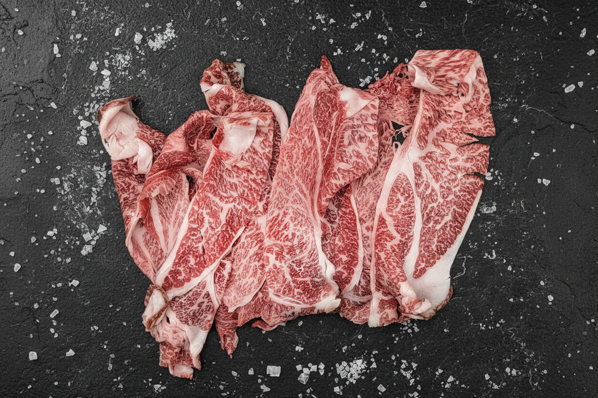 Raw marbled beef steaks on a textured surface