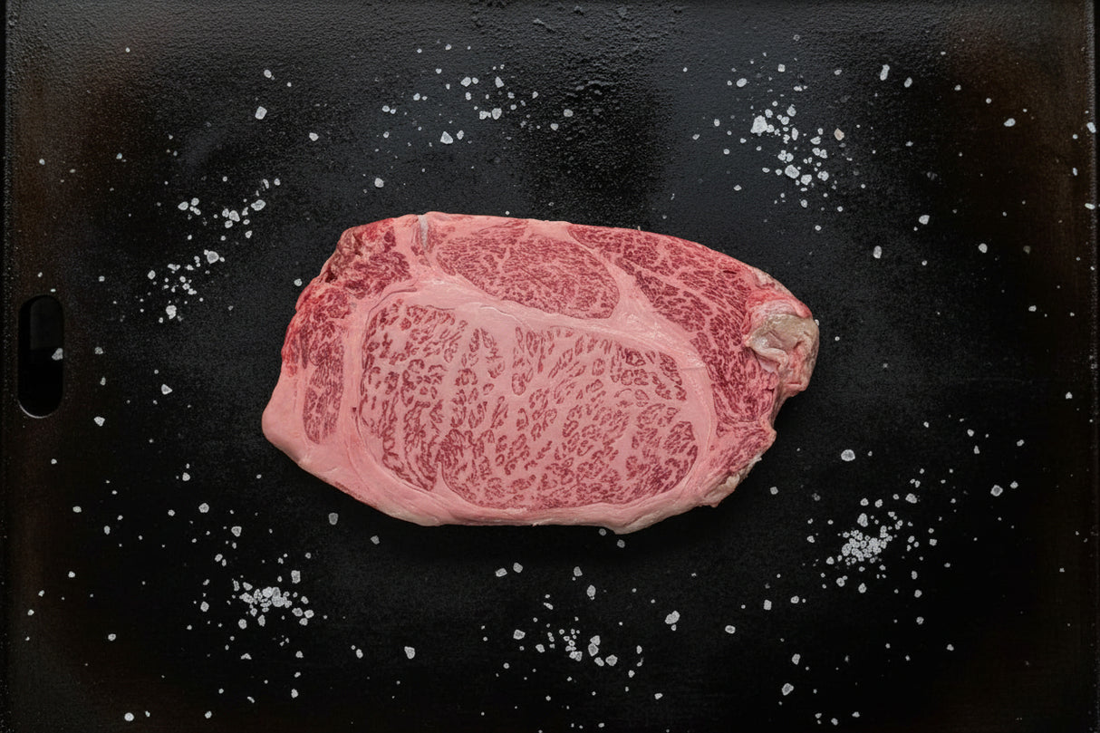 Raw steak on a dark surface